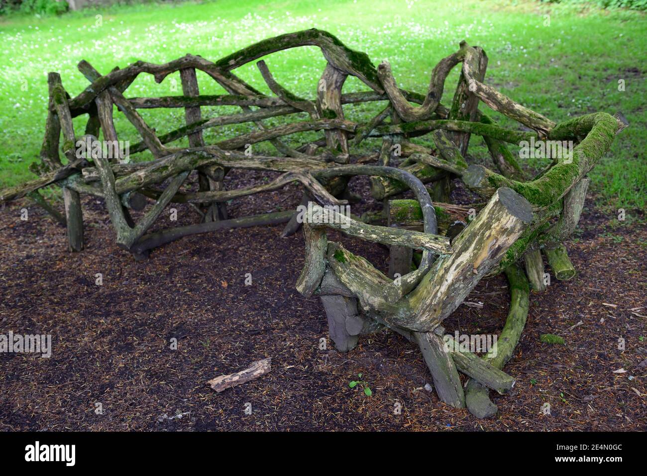 wooden,wood,garden bench,garden seating,seat made from tree branches, limbs,rustic furniture,outdoor,outdoor living,garden feature,gardens,garden furn Stock Photo