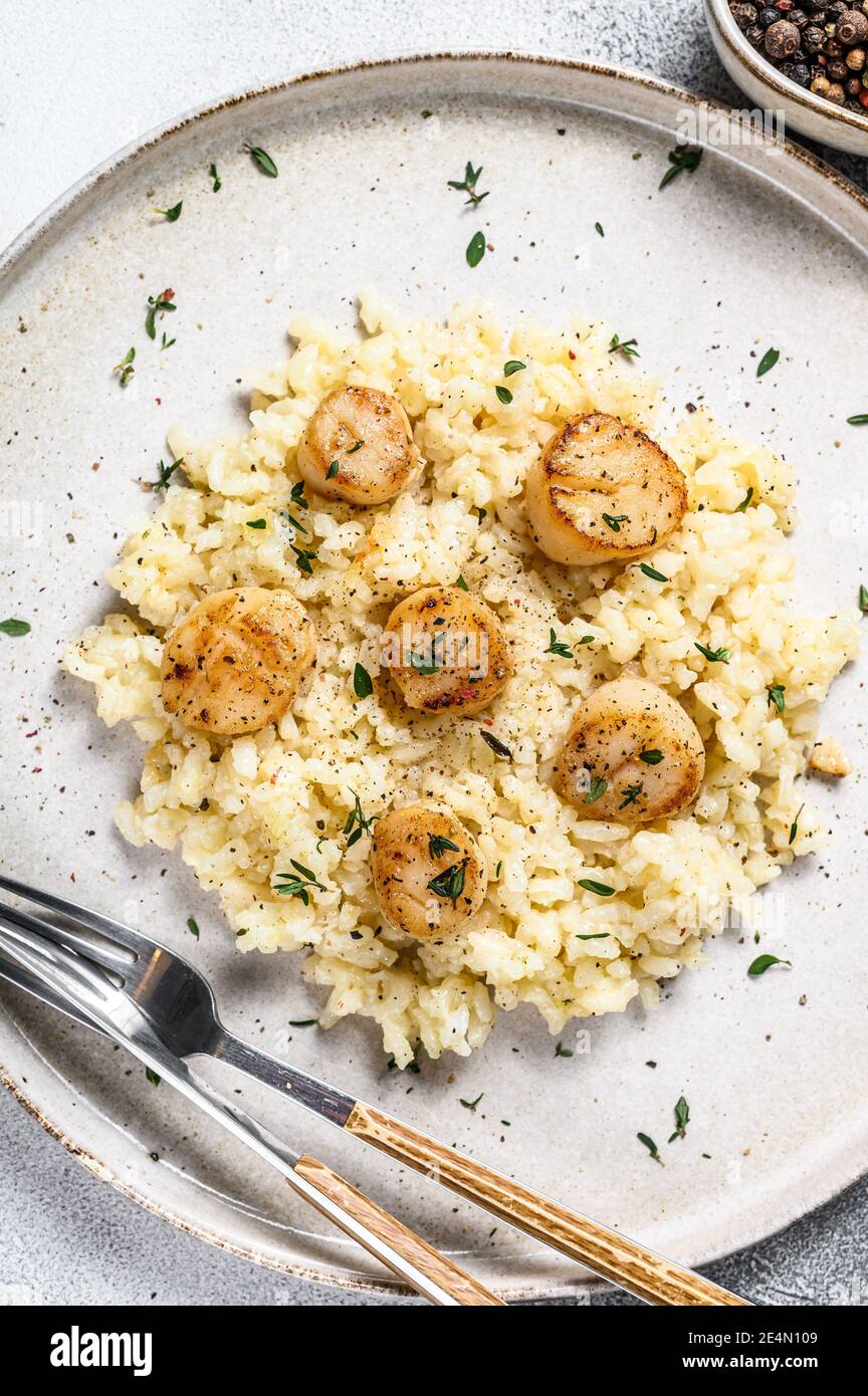 Italian Risotto with pan seared sea scallops. White background. Top