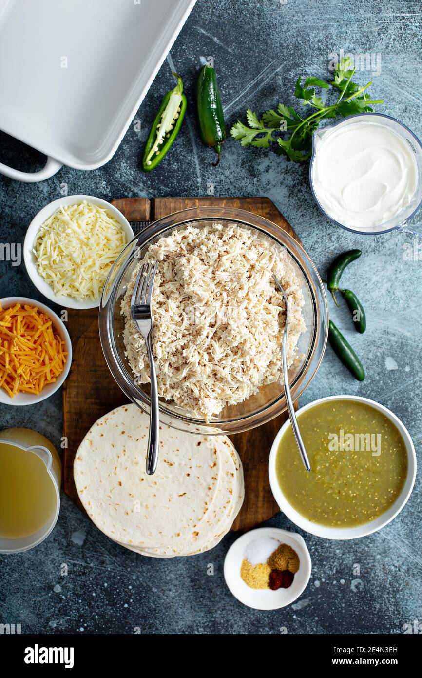 Making enchiladas with shredded chicken Stock Photo