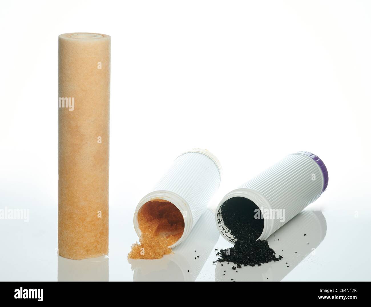 Three used water filters isolated. Sand, carbon and osmosis filtration Stock Photo