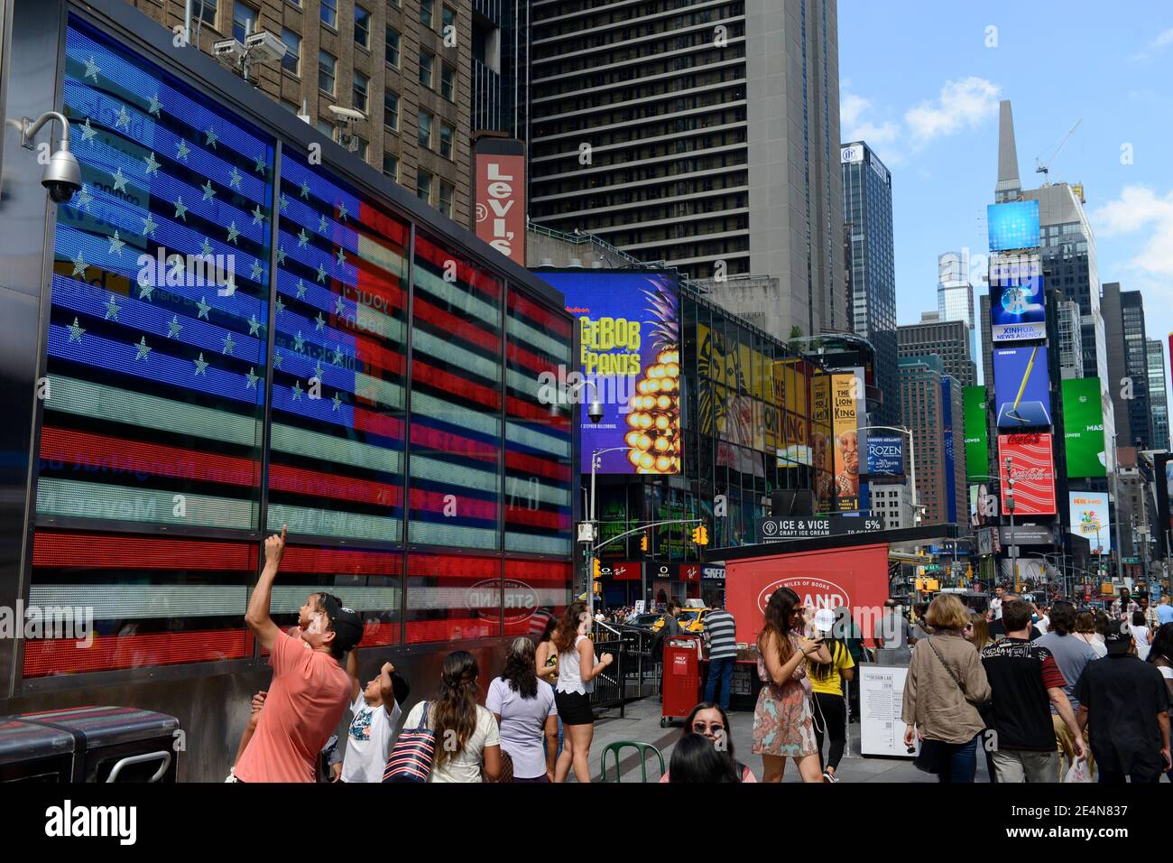 USA, New York City, Manhattan, Broadway and Times Square, large US flag at recruiting station of US armed forces Stock Photo
