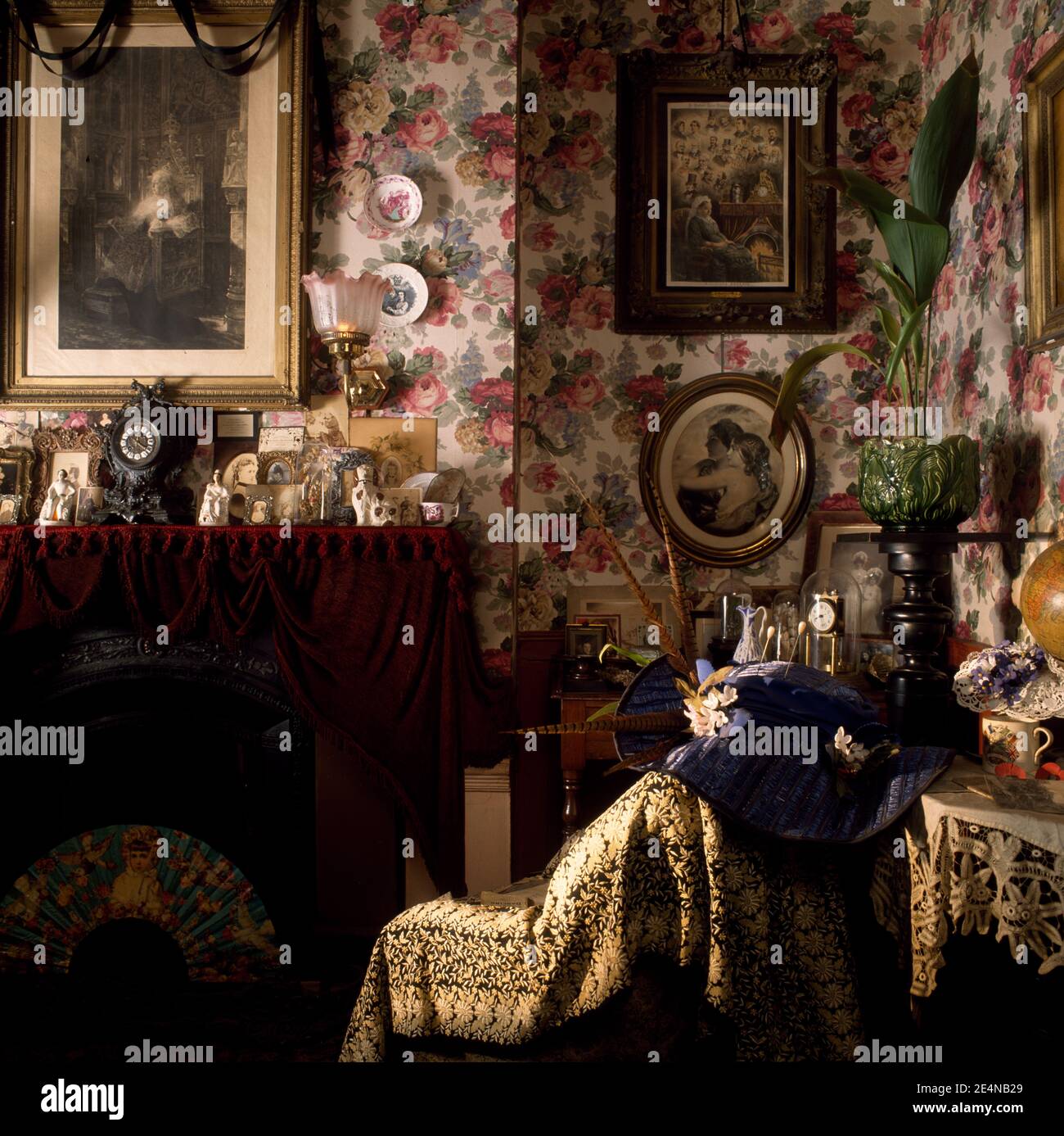 Victorian style living room with floral wallpaper and numerous pictures ...