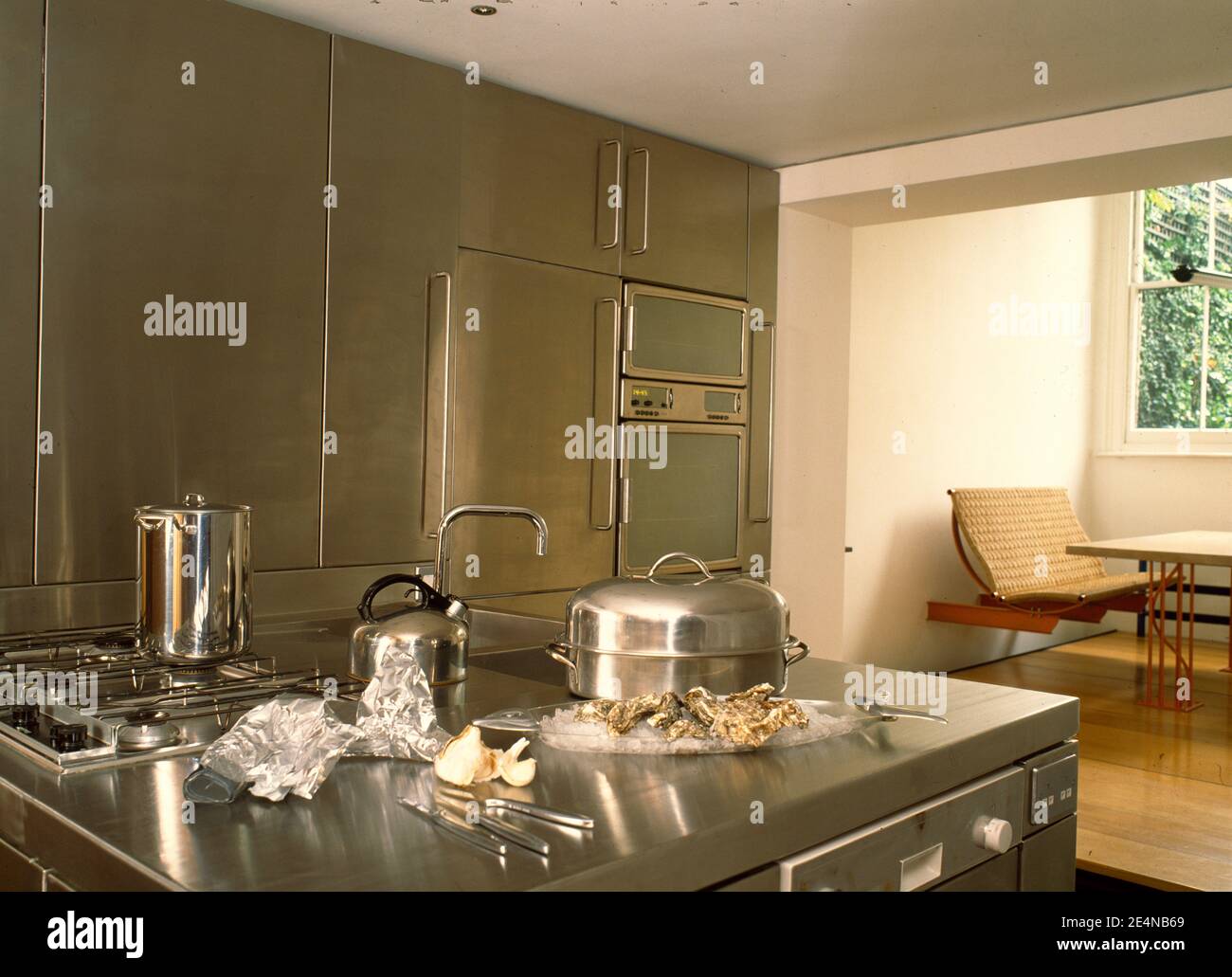 Stainless steel island unit with hob and sink Stock Photo Alamy