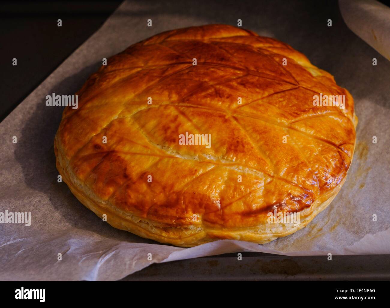 A French Galette des Rois (Kings cake) puff pastry cake baking in the