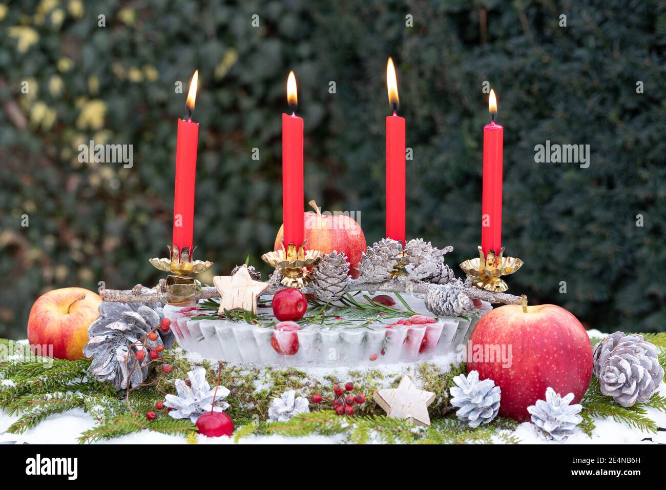 christmas garden decoration with red advent candles Stock Photo