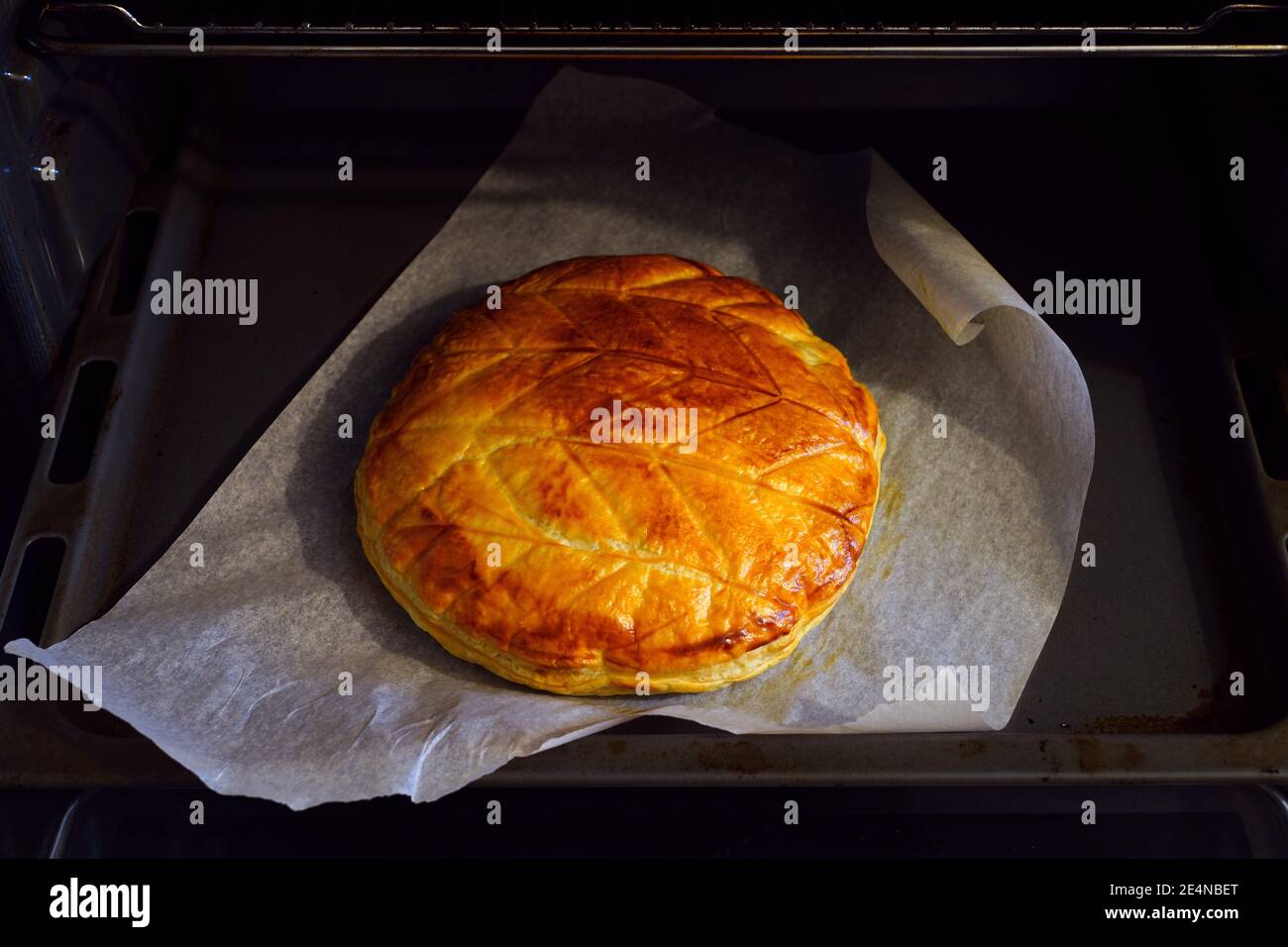 A French Galette des Rois (Kings cake) puff pastry cake baking in the