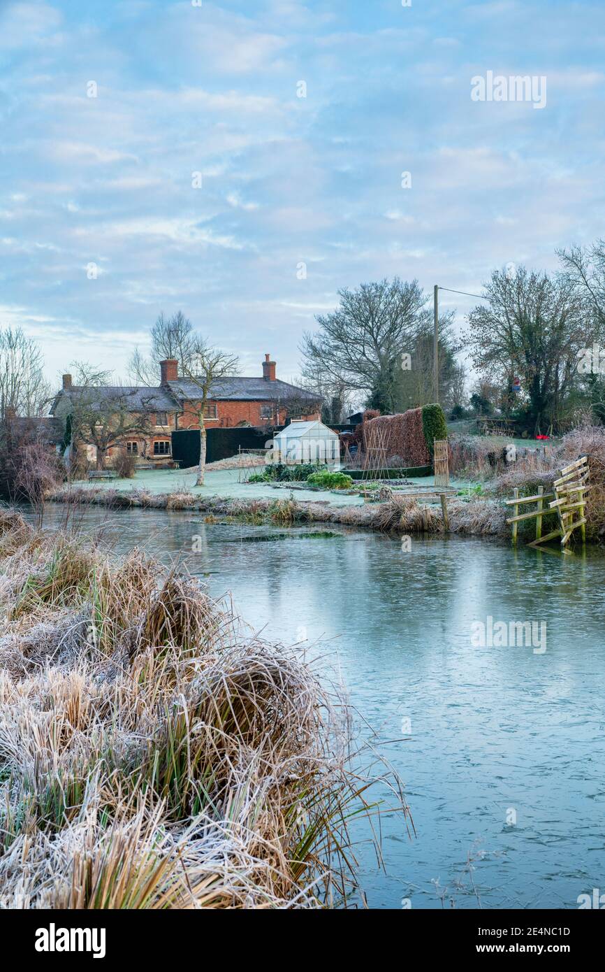 Canal bridge and cottage along the oxford canal in the january frost at