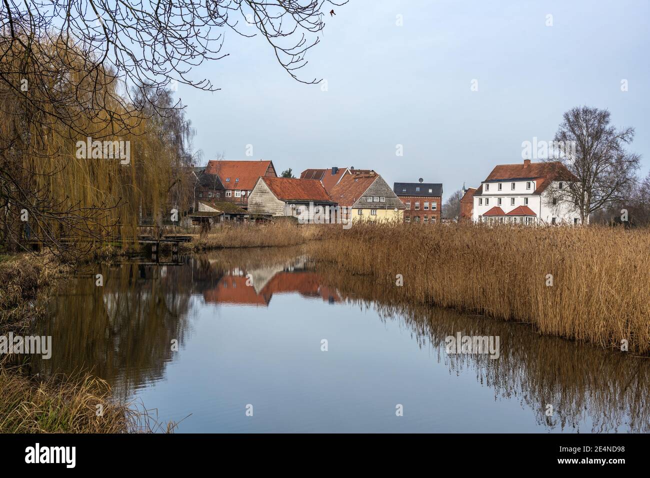 Mill pond and old houses with reflection in the small town Rehna in Mecklenburg-Vorpommern, northern Germany, copy space Stock Photo