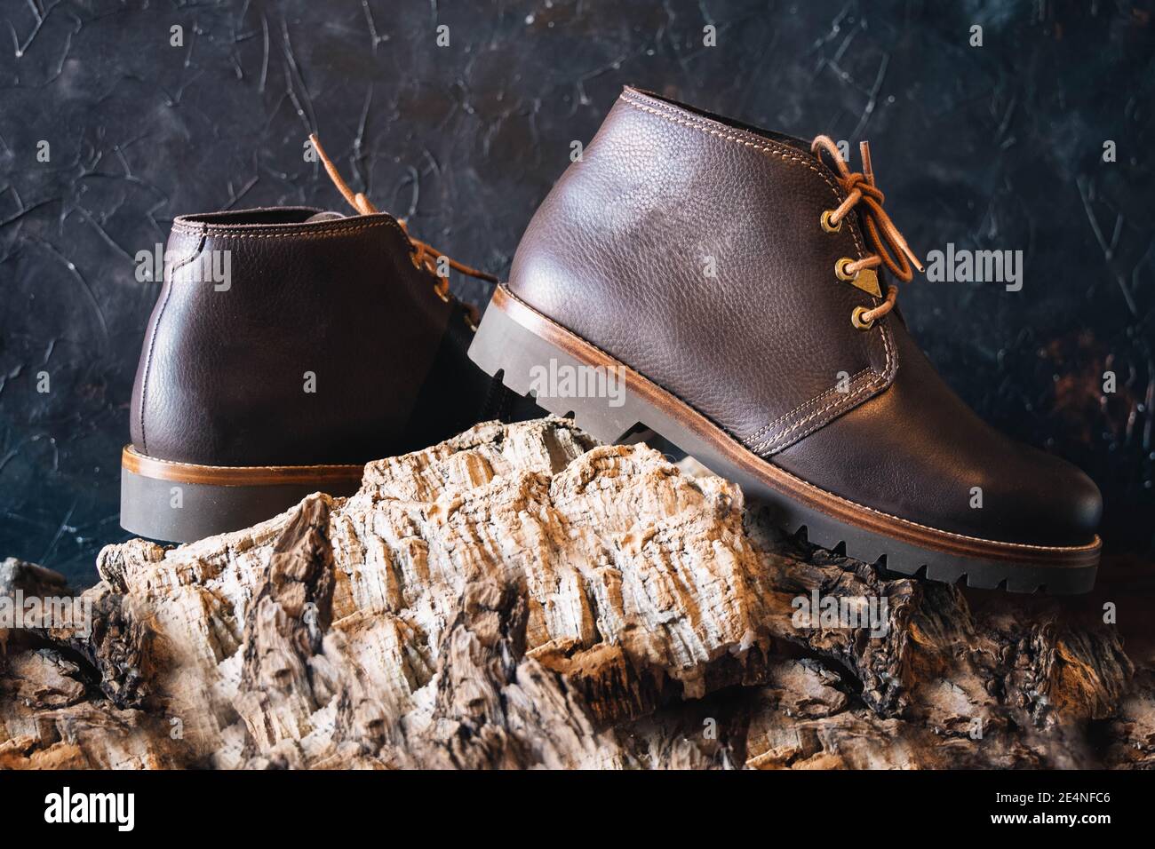 selective focus of brown leather winter footwear on bark logs with copy space Stock Photo