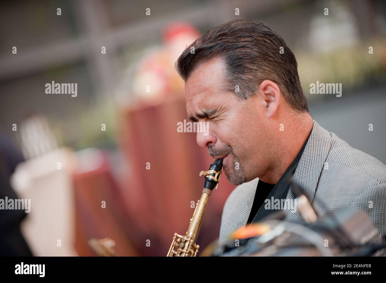 Duets of Saxophone and Guitar by Two Male Musicians at a Party Stock