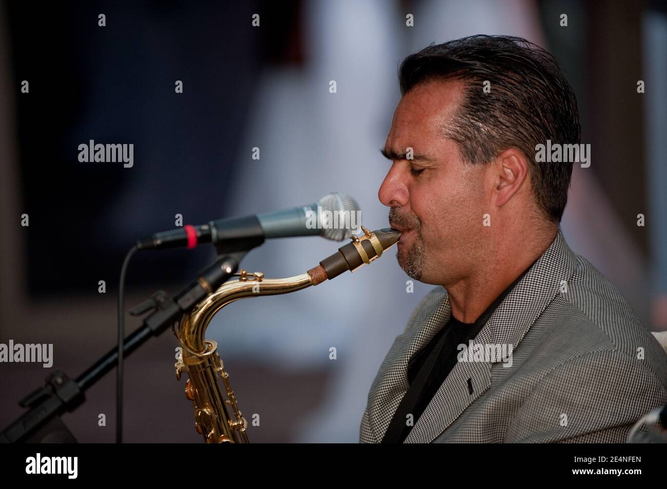 Duets of Saxophone and Guitar by Two Male Musicians at a Party Stock