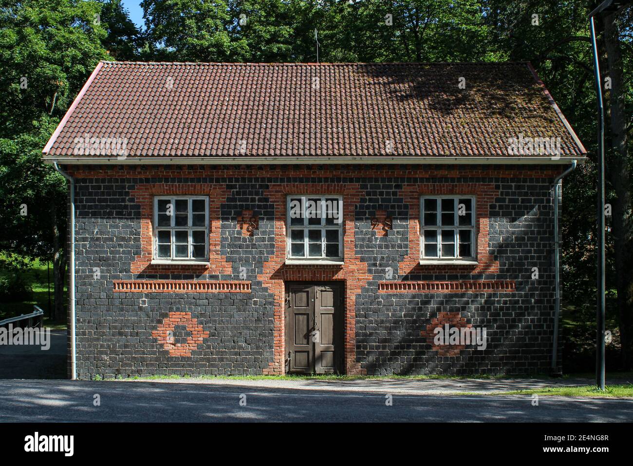 Black or slag brick mill building in popular day trip destination Fiskars, Finland Stock Photo