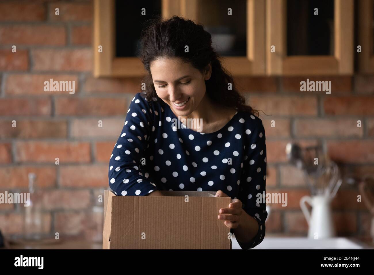 Excited female buyer unbox package shopping online Stock Photo