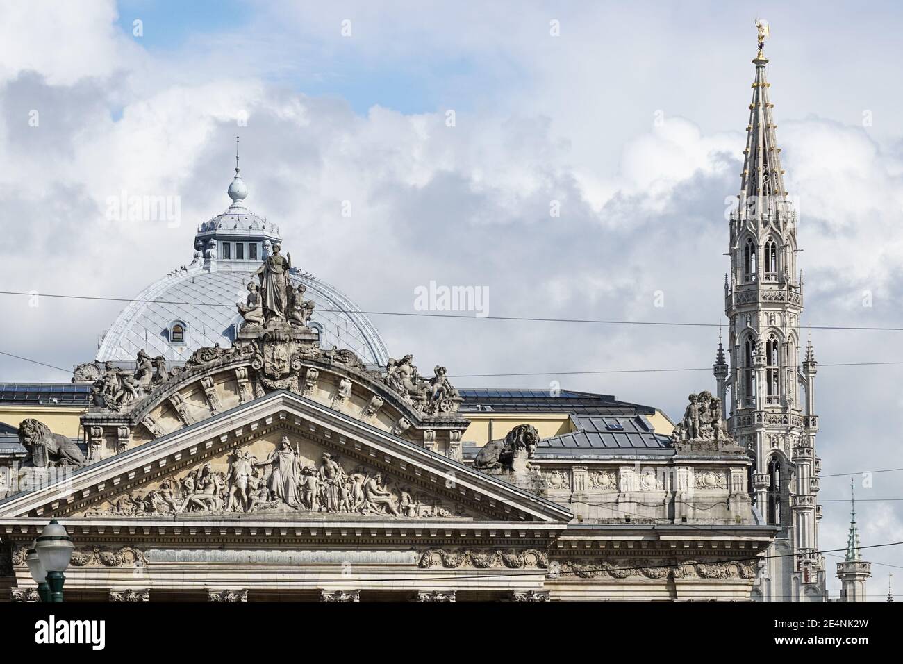 Pediment of Brussels Stock Exchange building and Town Hall spire in Brussels, Belgium Stock Photo
