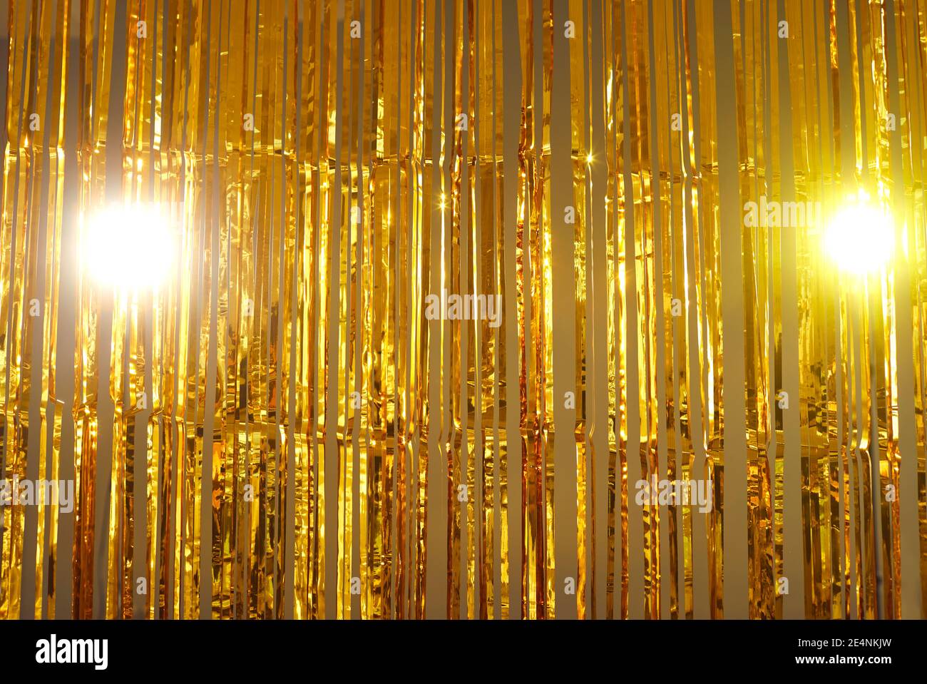 Golden foil fringe curtains hung as interior decor or backdrop for photo at a party Stock Photo
