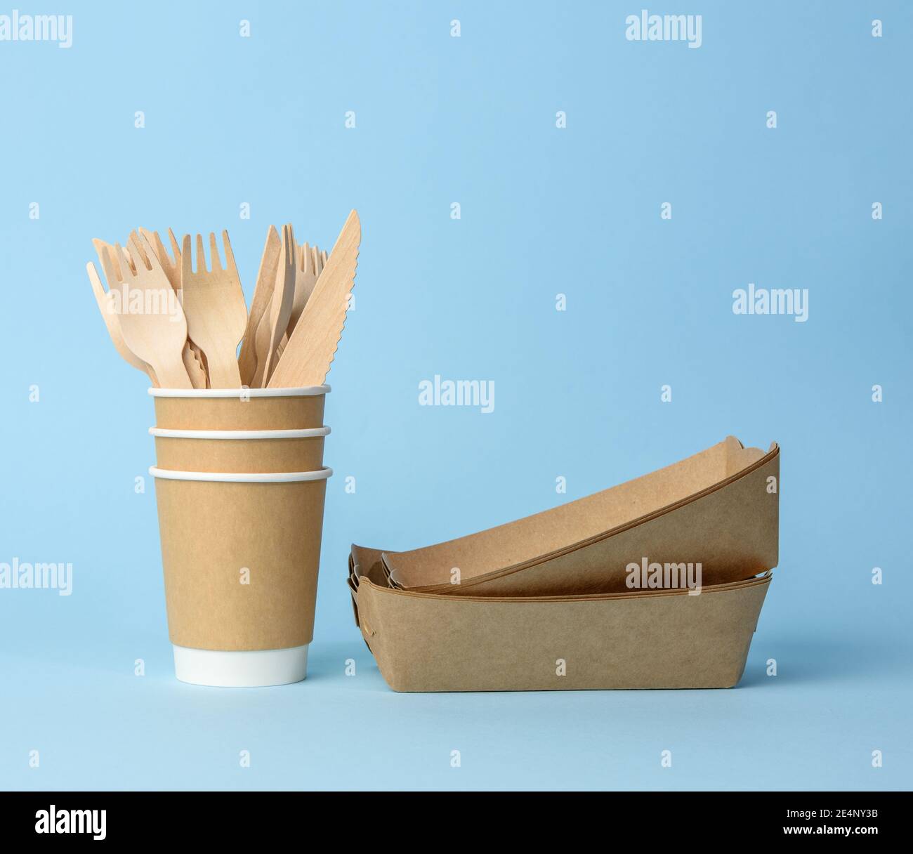 brown paper cup, plates on a blue background. Plastic rejection concept