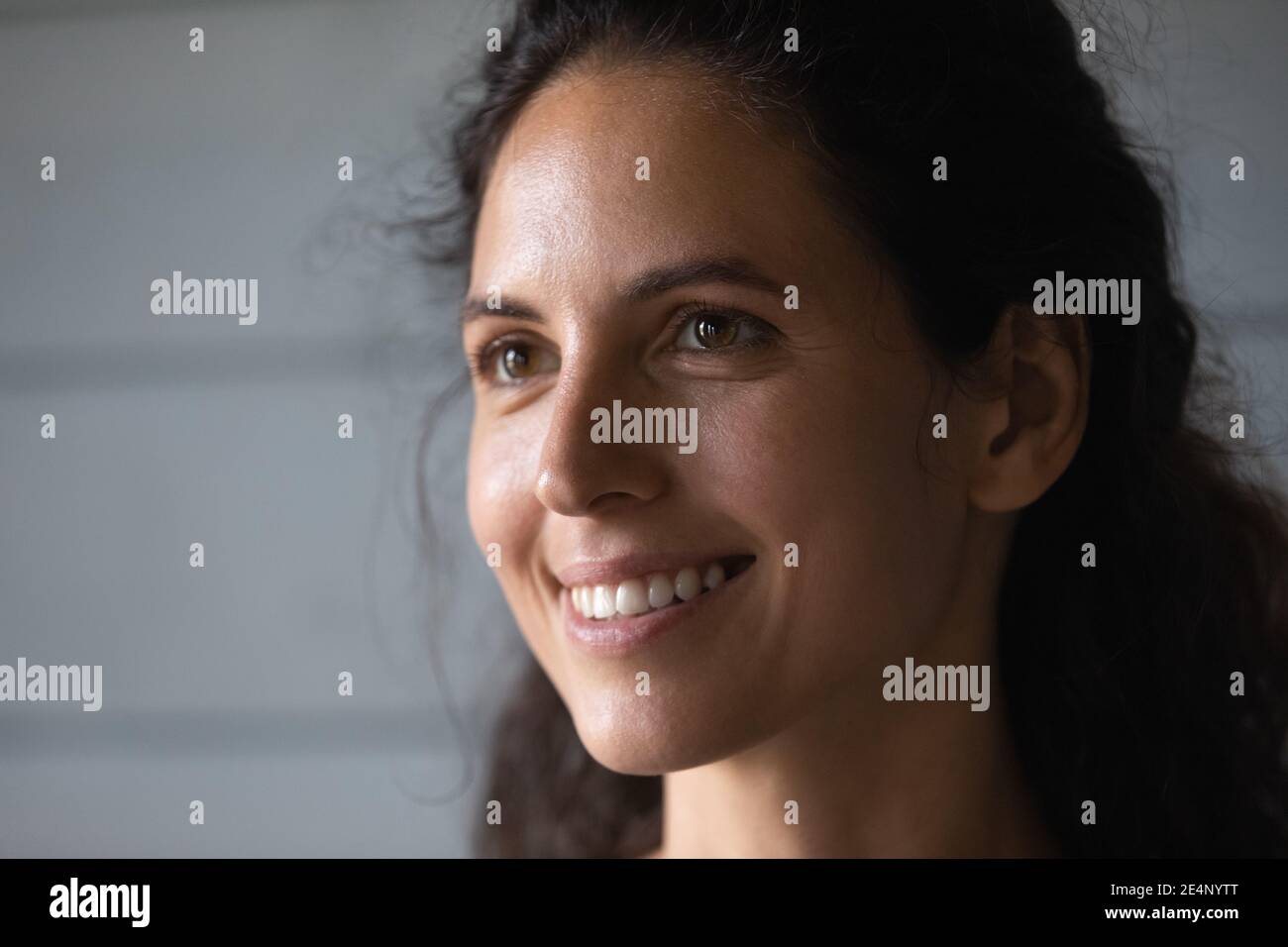 Close up of smiling woman look in distance dreaming Stock Photo
