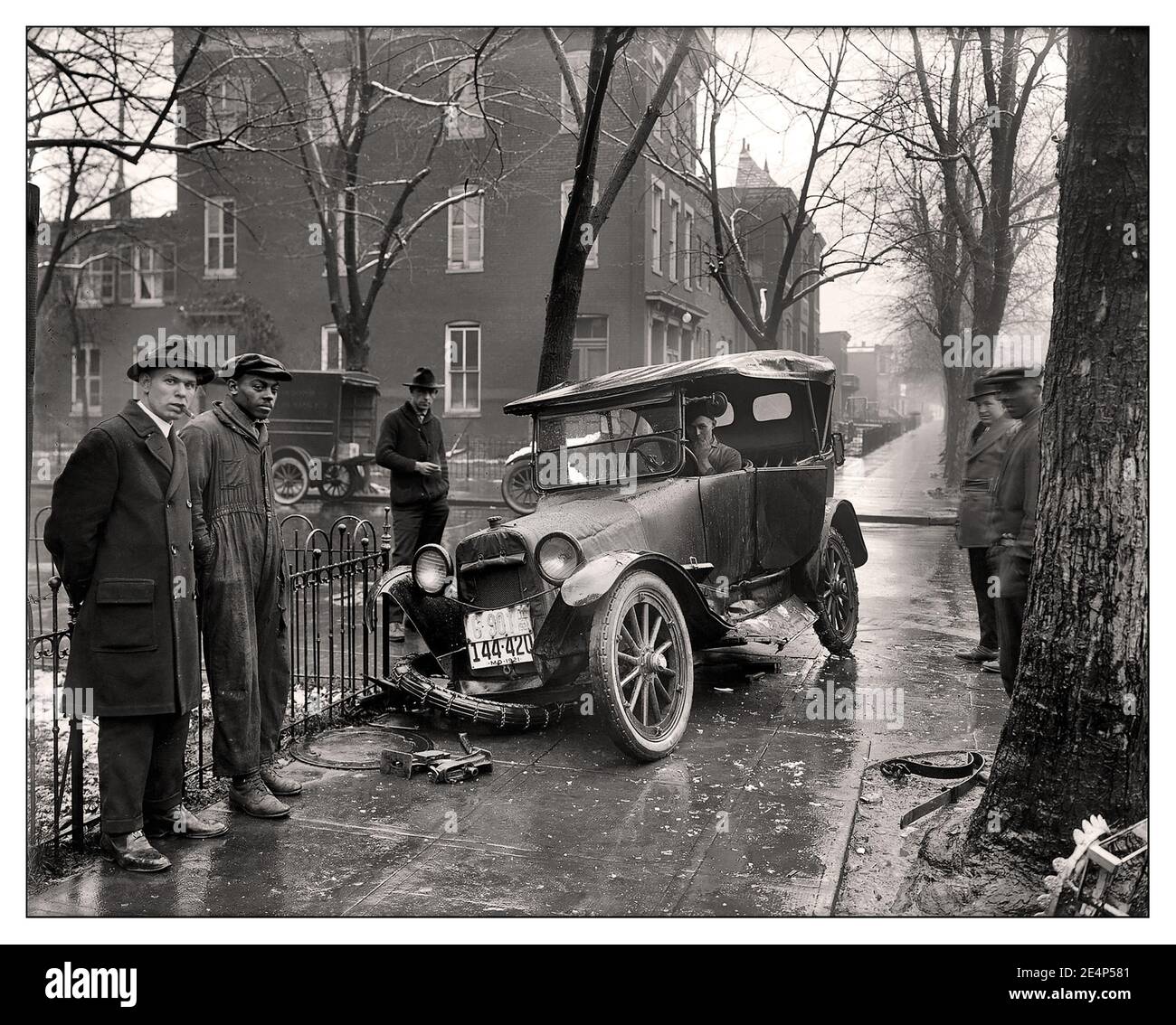 VINTAGE CAR CRASH 1920’s Auto Wreck in Washington D.C, 1921. 1. “Auto wreck.” Vehicular mishap on a wet wintry day on the streets pavement (and sidewalks) of Washington, D.C. USA  America Stock Photo