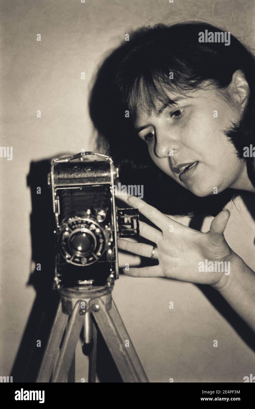 Young woman with antique photo camera Stock Photo