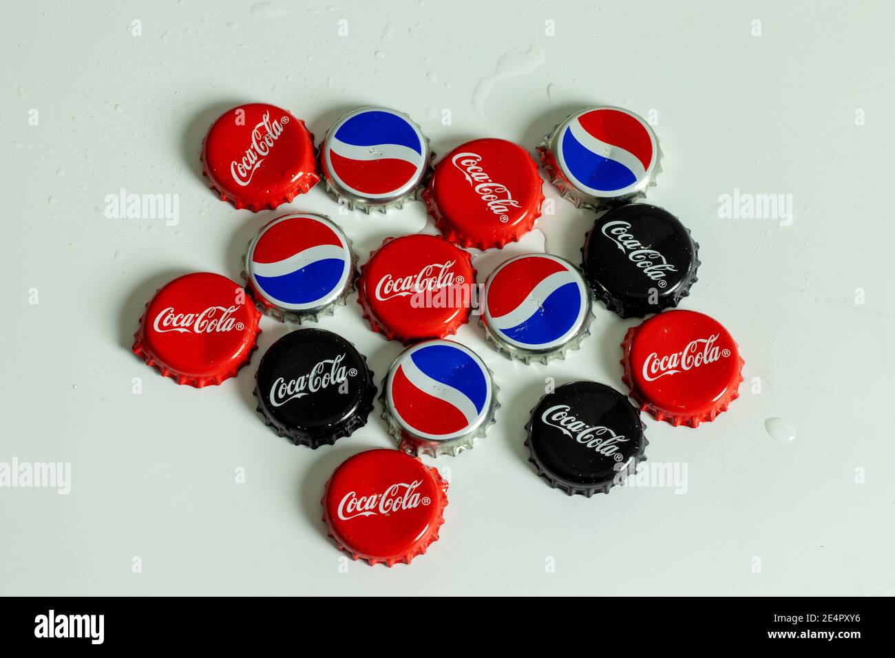 New York, USA - 1 January 2021: Top view of Pepsi and Coca-Cola bottle cap with logo. Coke brand, Illustrative Editorial Stock Photo
