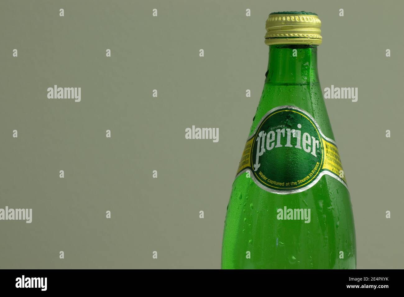 New York, USA - 1 January 2021: Perrier mineral water logo on bottle with copy space on backgorund, Illustrative Editorial Stock Photo