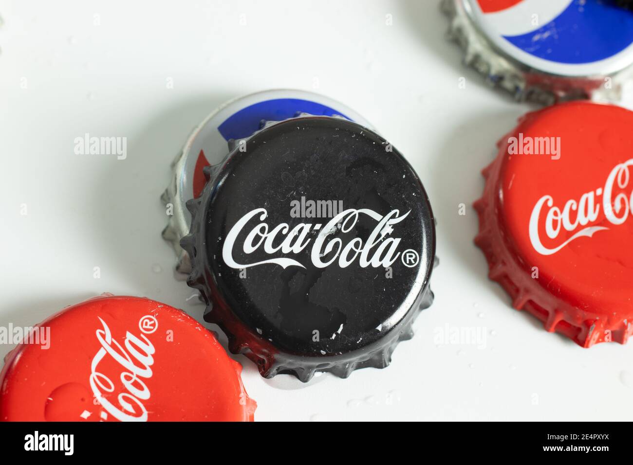New York, USA - 1 January 2021: Coca-Cola logo on bottle cap close up top view. Black Coke label, Illustrative Editorial Stock Photo