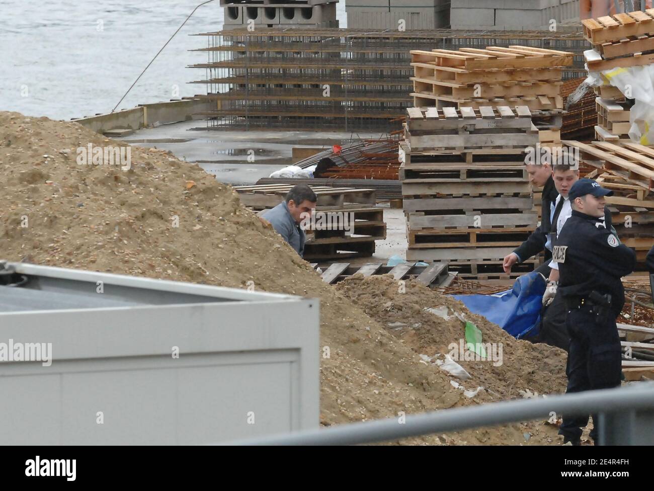 Forensic officers lift up the body of an unidentified woman, alledgedly