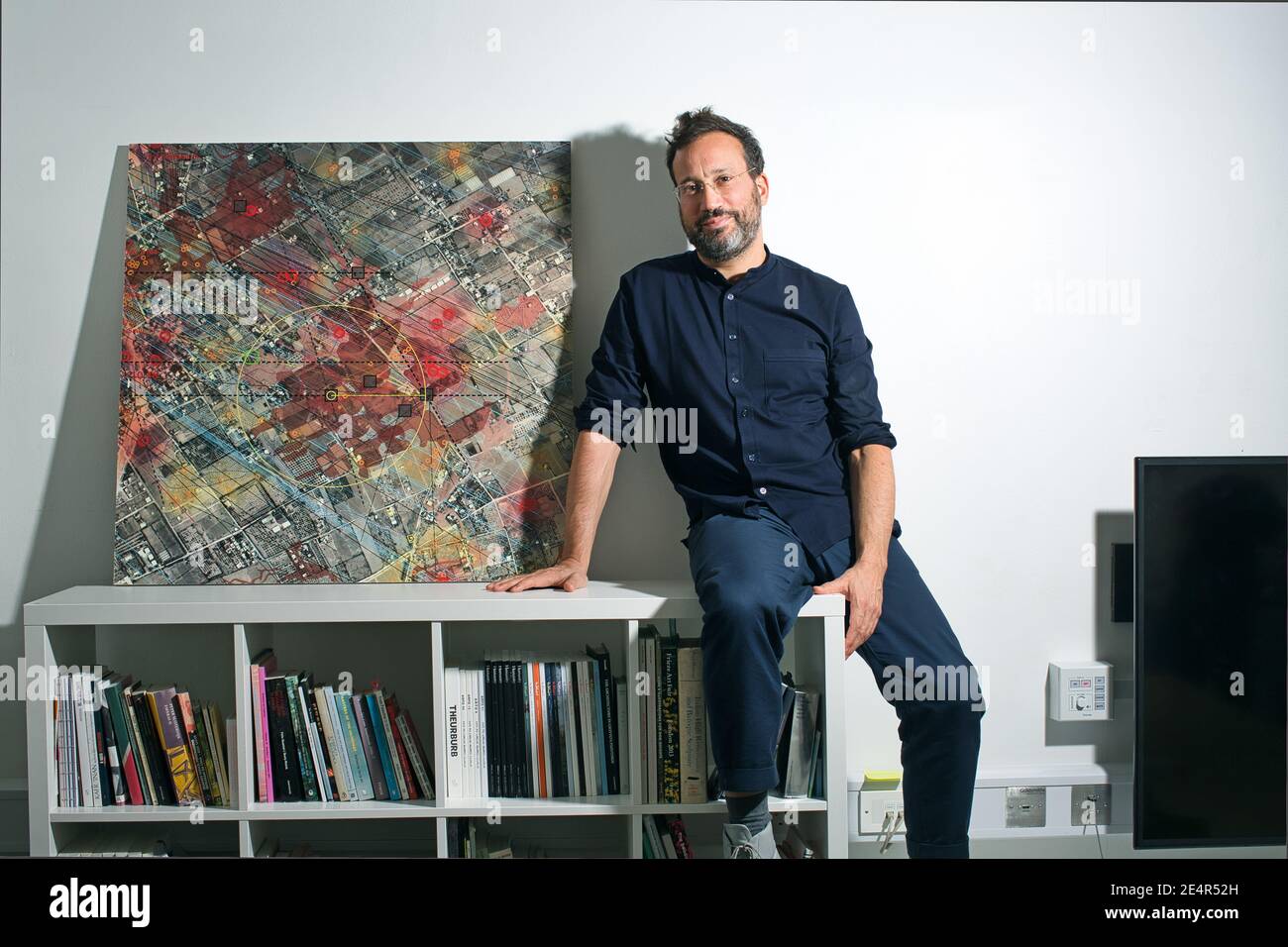 England / London /Forensic Architecture/ Eyal Weizman, the founder of Forensic Architecture sitting next to a satellite image from Rafah. Stock Photo