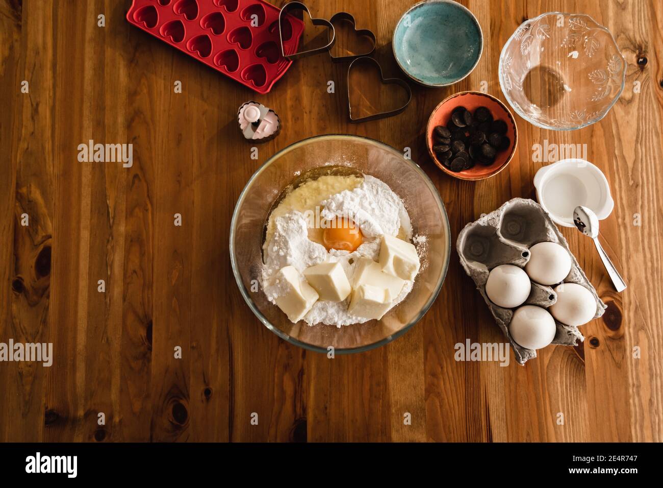 Mixing baking powder in egg dough to prepare pie cake cookies. Stock Photo