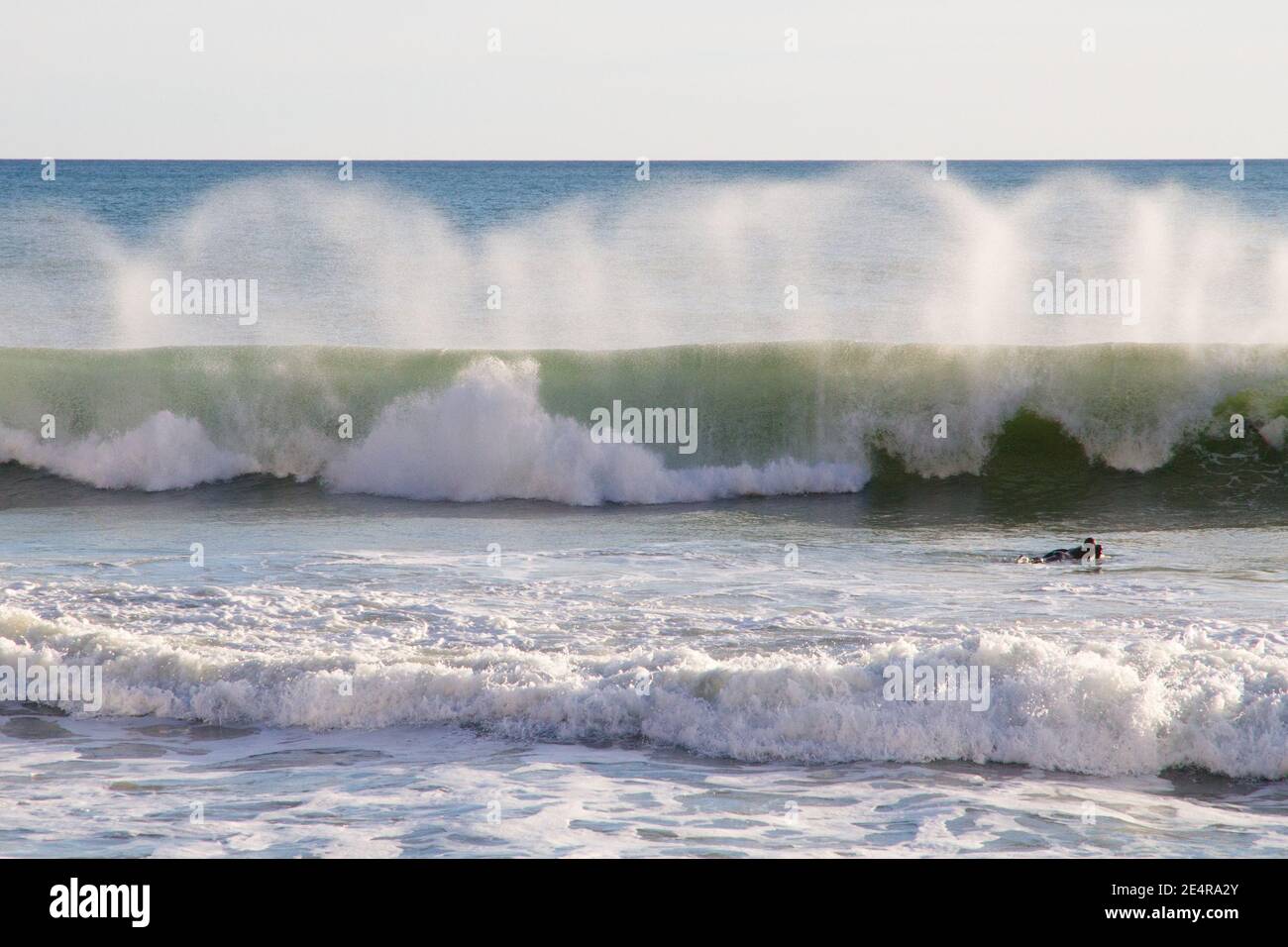 Surfer surfing wave jumping on surf board. Mallorca Spain Stock Photo