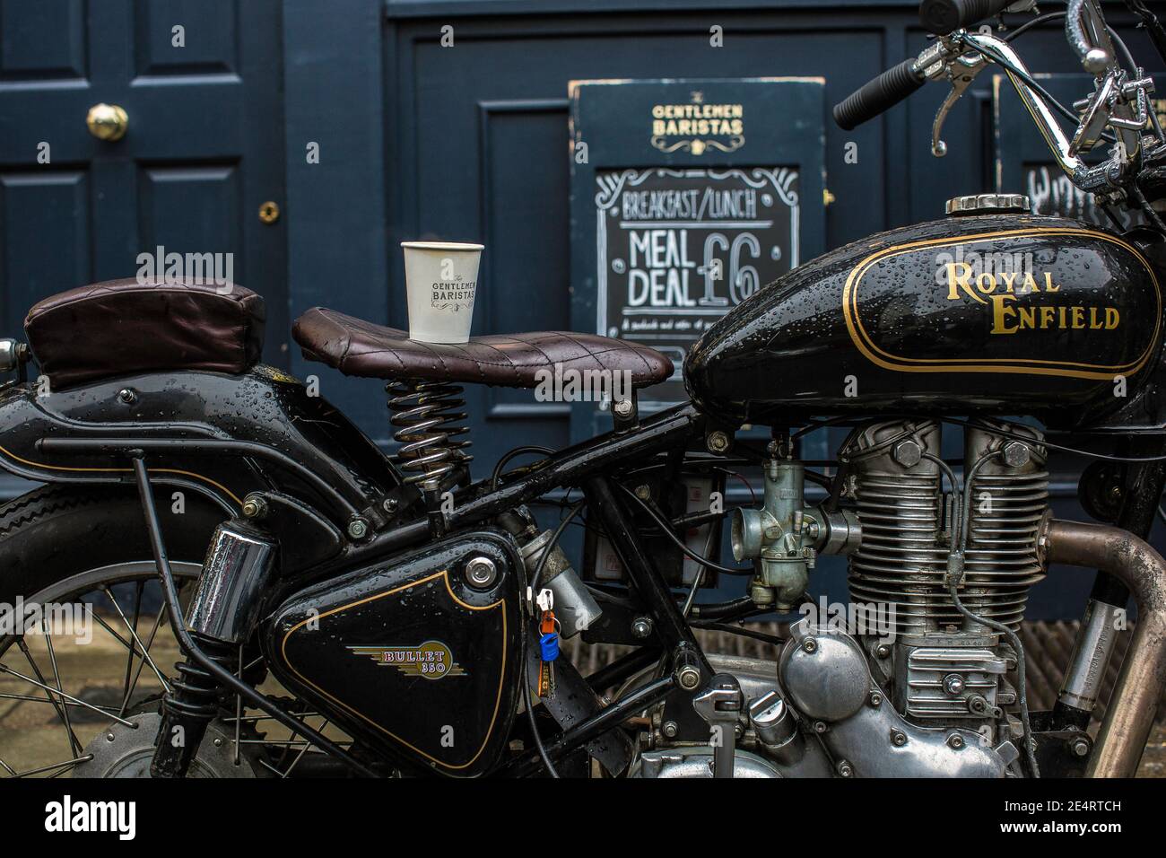 classic motorcycle parked in front of a coffee shop Stock Photo