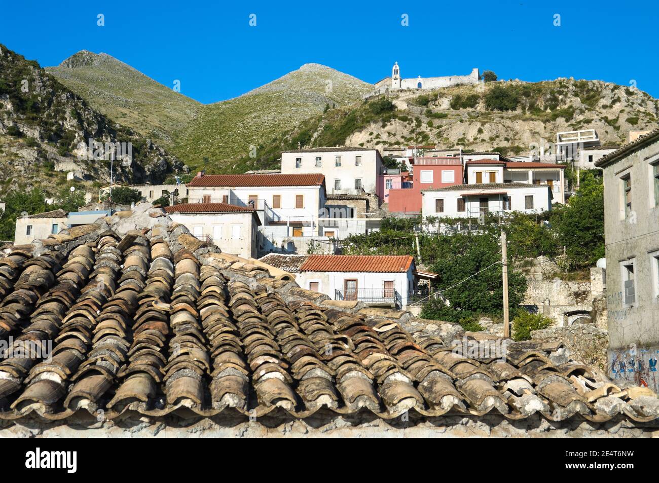 the village of Dhermi, dominated by white church of St. Mary on the hill, Albania Stock Photo