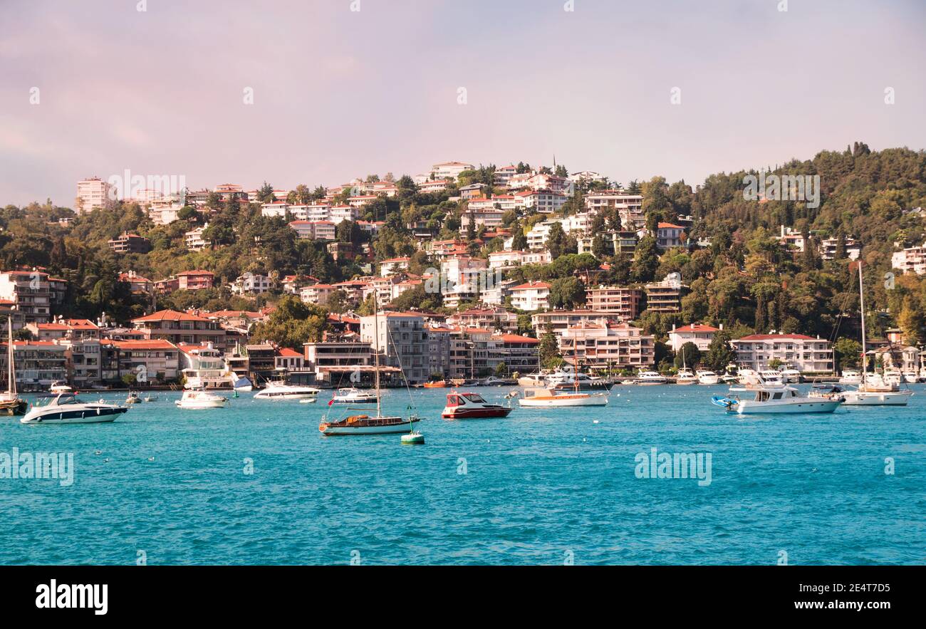 View on marine in Bosporus Strait with boats and ships before hilly residential blocks of Bebek neighborhood behind Cevdet Pasa street in Besiktas Stock Photo