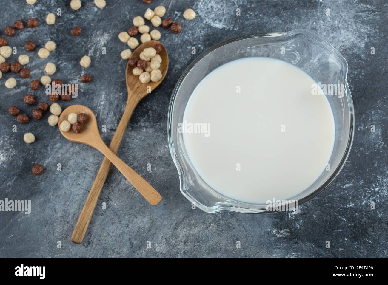 Bowl of milk and cereal balls on marble background Stock Photo