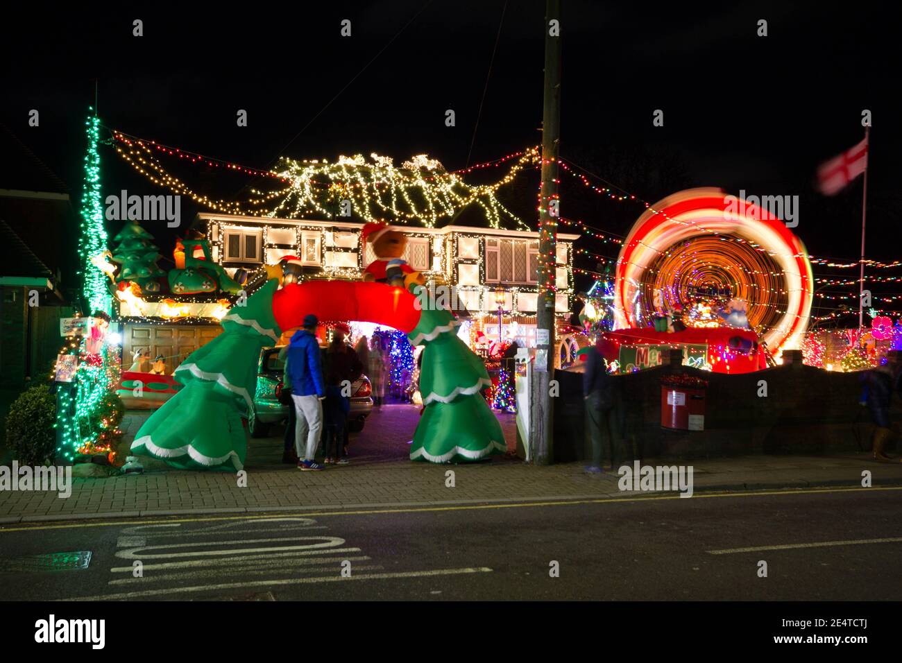man standing at entrance to Christmas lights show outside a house in Bromley London Stock Photo