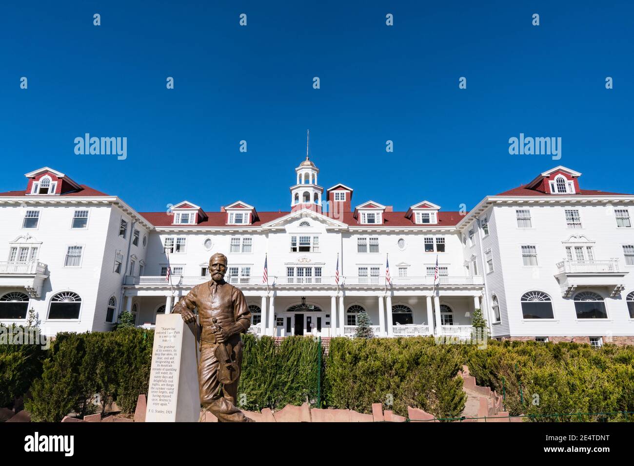 Estes Park, CO - October 31, 2020: Exterior of the historic Staley Hotel in Estes Park near Rocky Mountain National Park with statue of F. E. Stanley Stock Photo