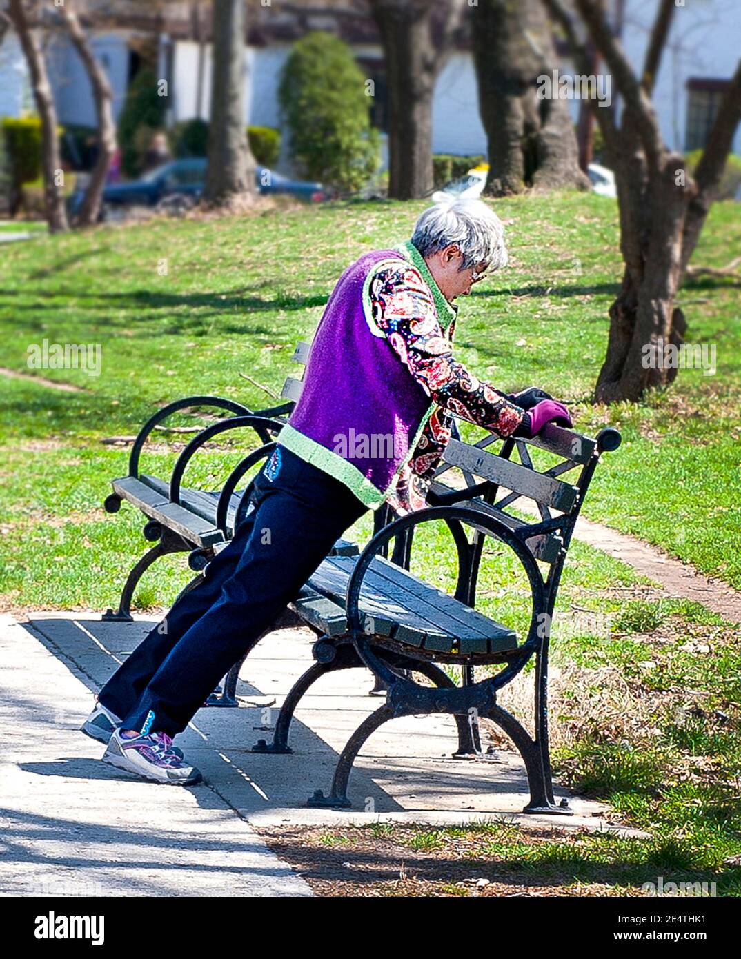 elderly woman doing exercises at park Stock Photo