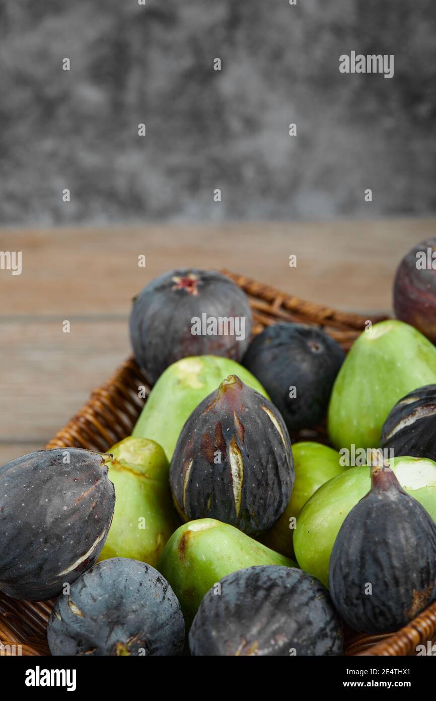 Ripe green and black figs in a basket Stock Photo