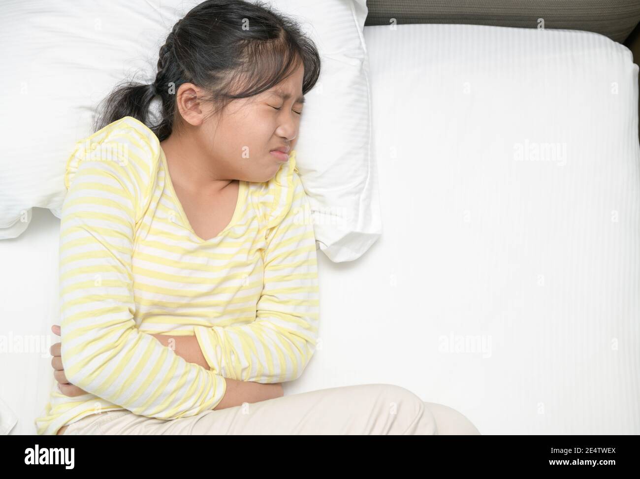 japanese diarrhea girls asian girl suffering from stomachache and lying on bed. diarrhea or healthy  concept Stock Photo - Alamy