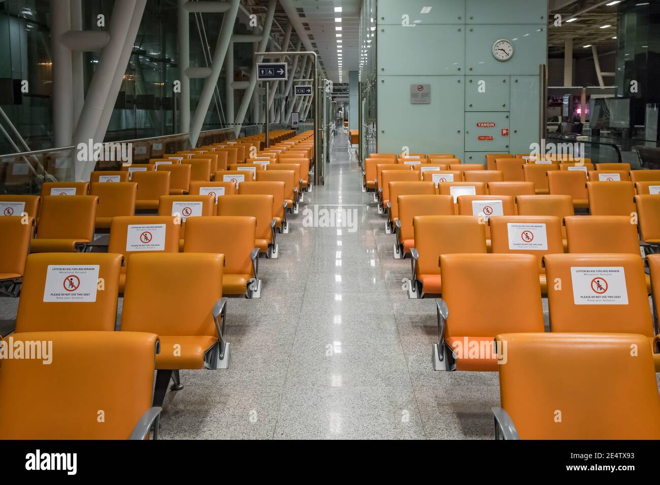 Signs on the chairs reminding about importance of social distancing during pandemic of Covid-19 Stock Photo