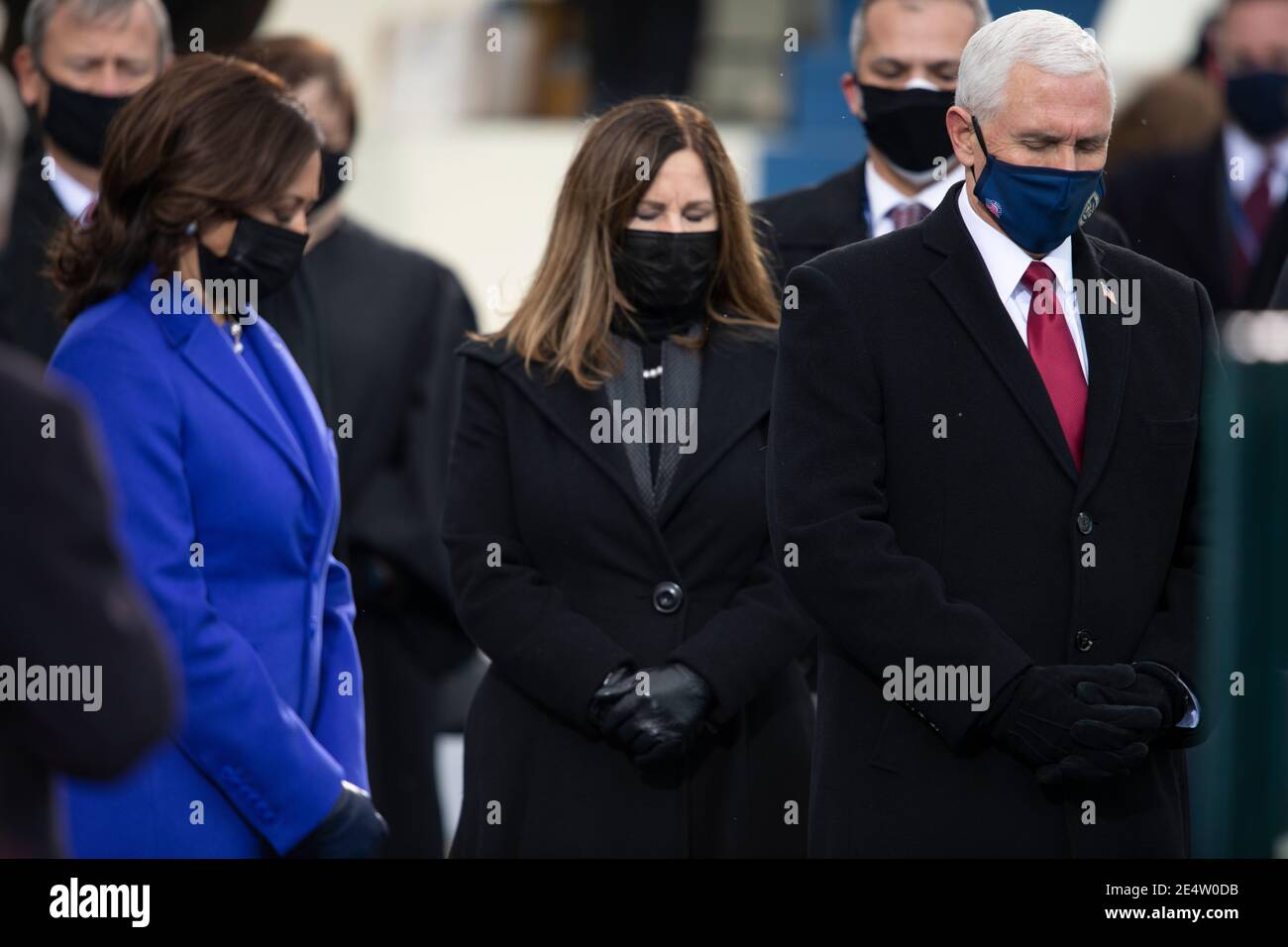 U.S. Vice President Mike Pence, Karen Pence and Vice President elect Kamala Harris bow their heads for the invocation during the 59th Presidential Inauguration ceremony at the West Front of the U.S. Capitol January 20, 2021 in Washington, D.C. Stock Photo