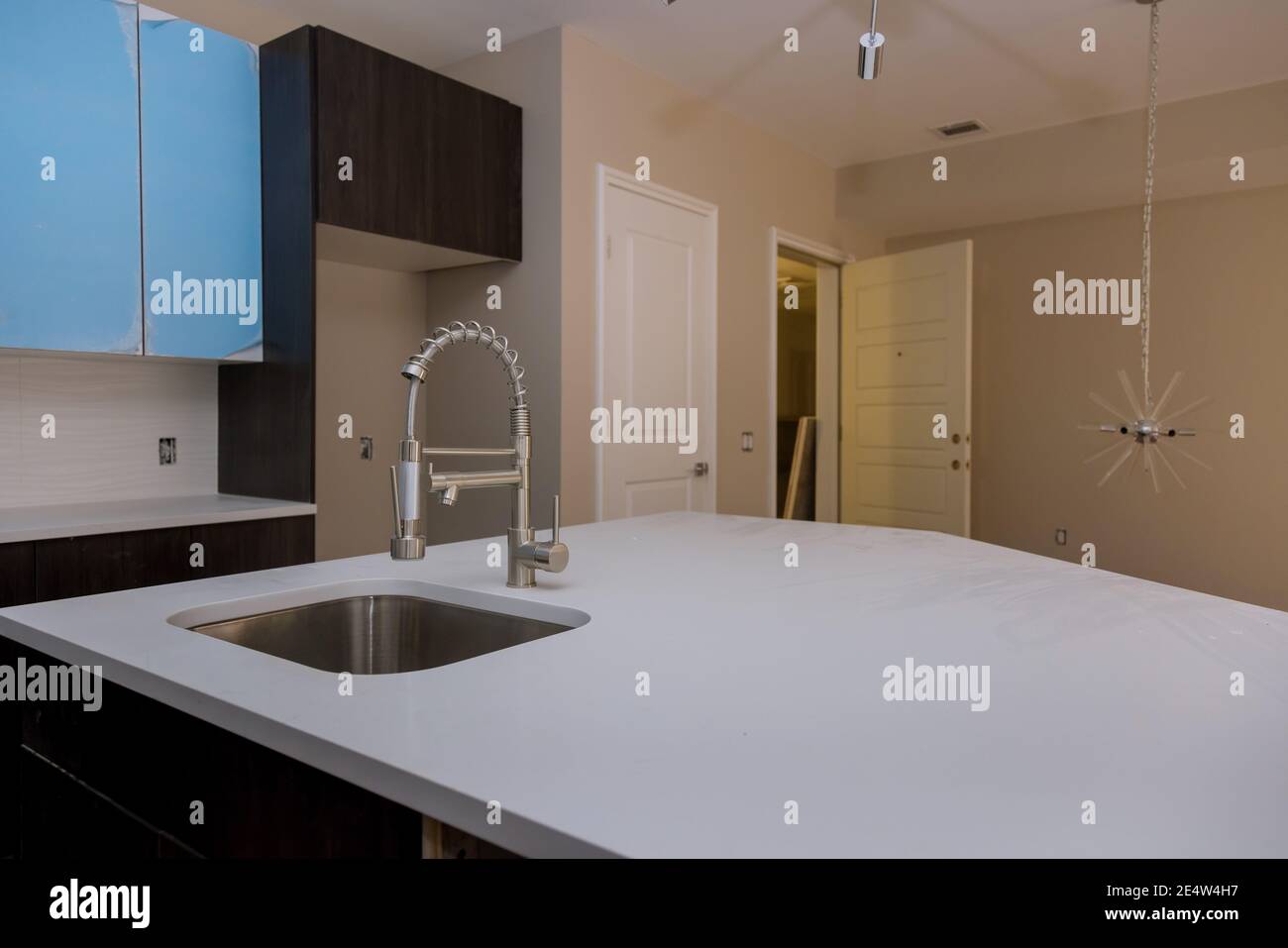Modern domestic kitchen cabinets with new appliances and sink in ...