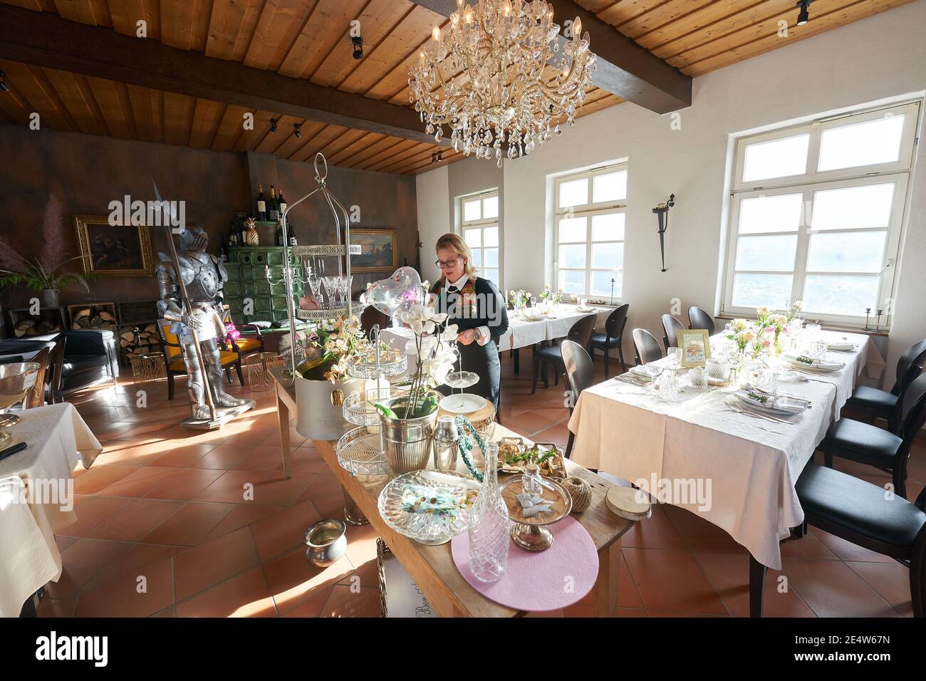 Kamp Bornhofen, Germany. 23rd Jan, 2021. Karolin König-Kunz, leaseholder of Sterrenberg Castle, sets the tables festively. From mid-June to mid-October, almost every Saturday at the castle is booked for weddings. (to dpa 'Corona torments wedding restaurants - still many bookings') Credit: Thomas Frey/dpa/Alamy Live News Stock Photo