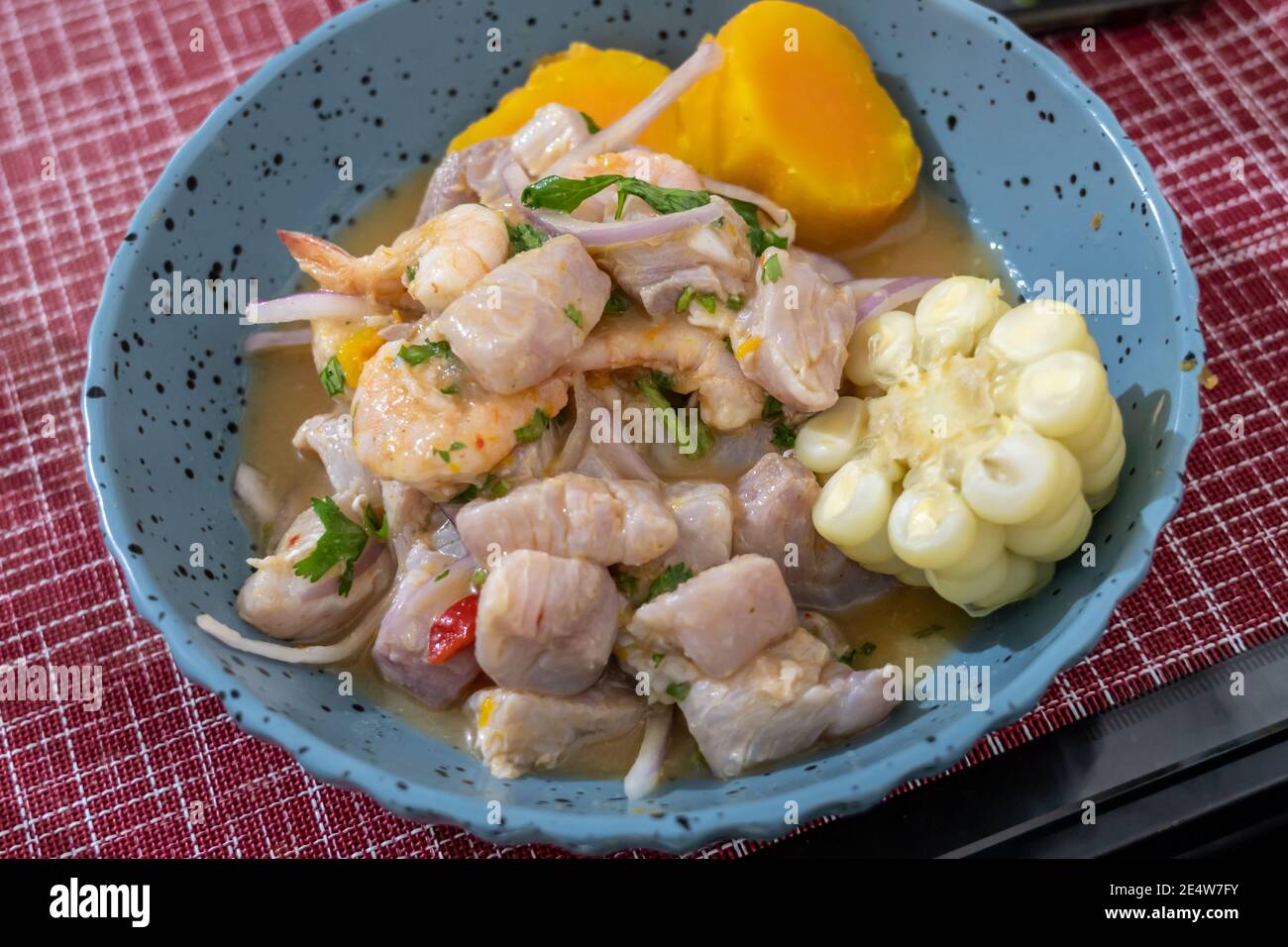 Peruvian ceviche with fish, scallop, shrimp, choclo, yuca, onion and