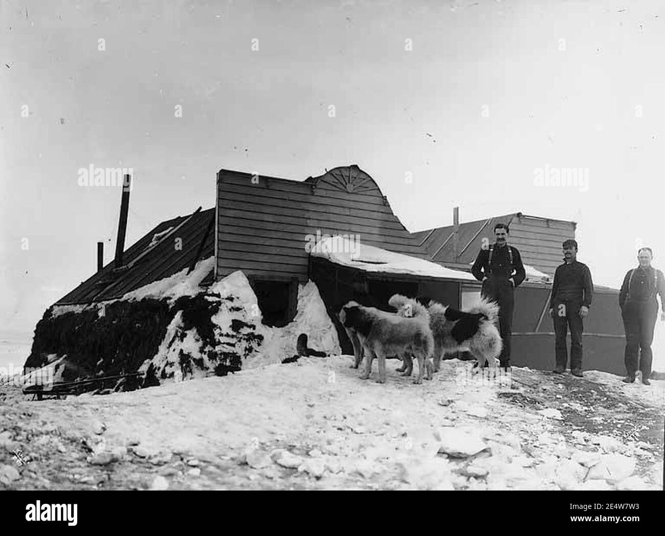 Men and dogs in front of cabin in Deering, Alaska, circa 1905 (AL+CA