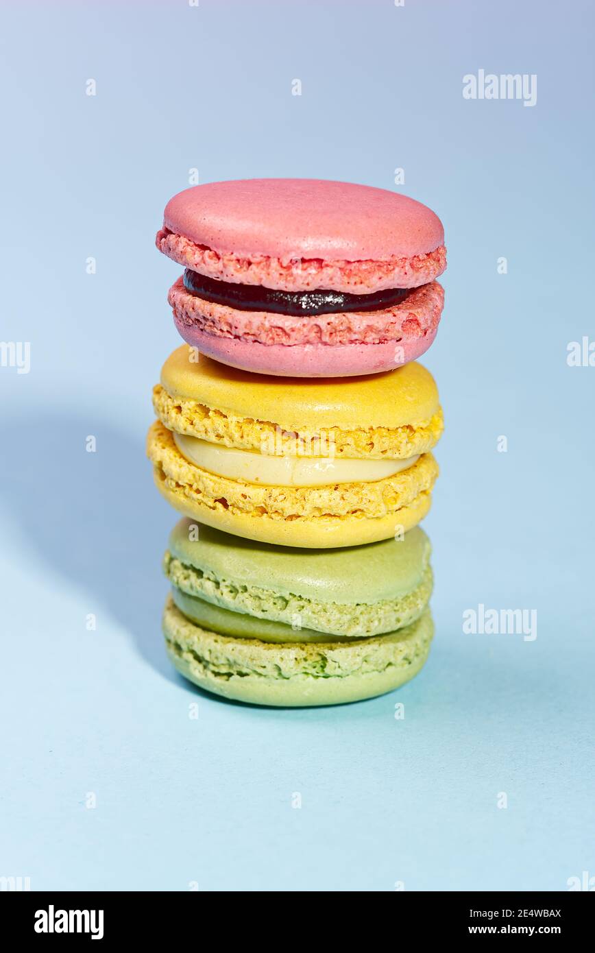 Macaron. Traditional french colorful macarons close up, macro on blue background Stock Photo