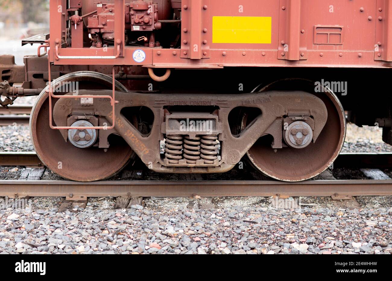 Railroad hopper car truck wheels and axles on the tracks, at the BNSF