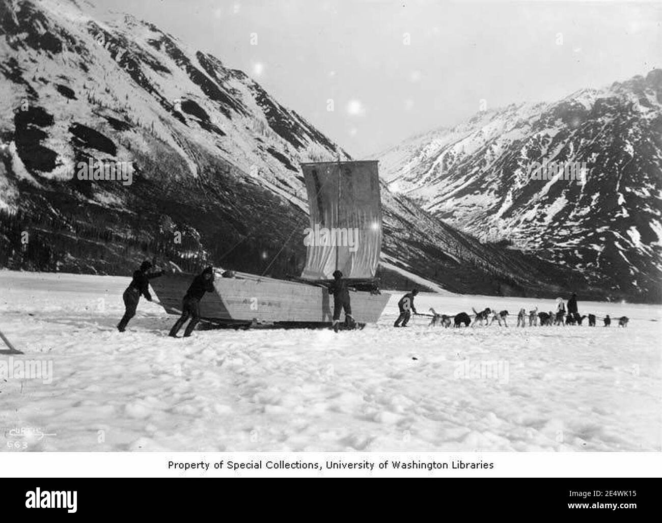 Men and dogsled navigating large sled with sail on Windy Arm, Tagish Lake, ca 1898 Stock Photo