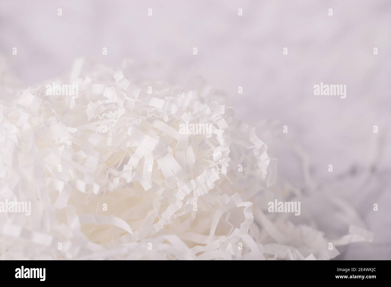 Background of white shredded paper. Strips of sliced corrugated paper