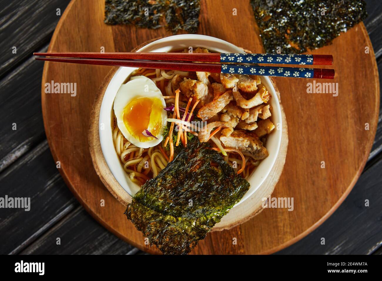Japanese ramen soup with chicken, egg, garlic and noodles on a dark
